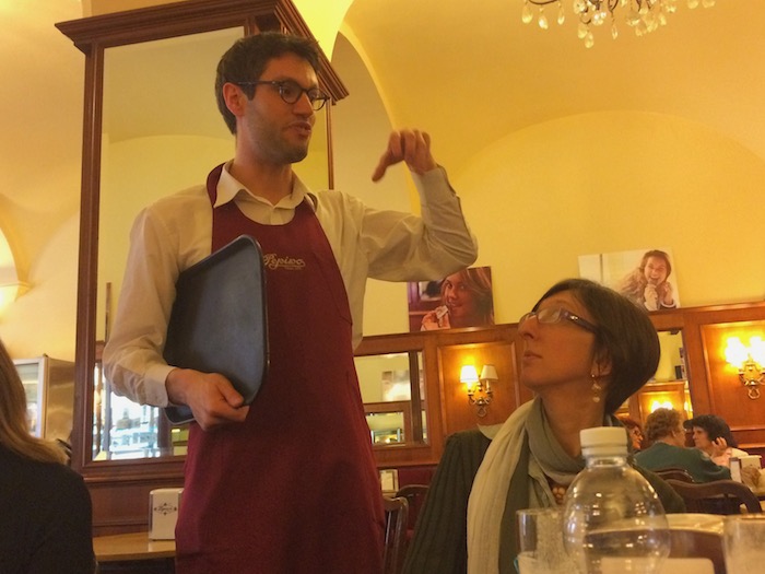 Waiter in Gelateria Pepino Gelato offering Italian ice cream